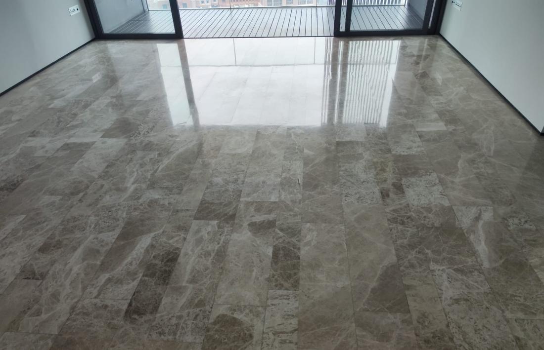 Polished Emperador-style marble floor in a condo living room