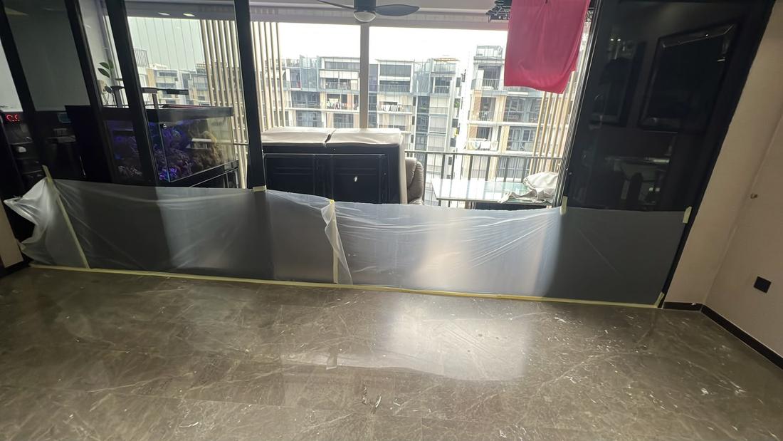 Windows and cabinets masked before marble polishing
